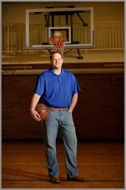 Cameron Mills holding a basketball in a gym